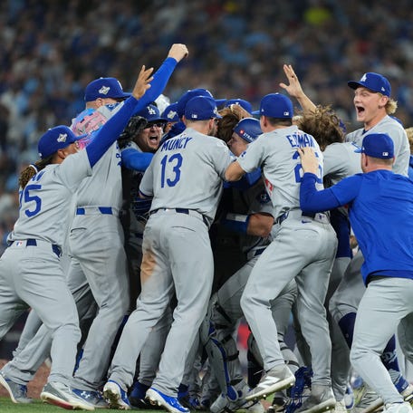 The Los Angeles Dodgers celebrate after defeating the Toronto Blue Jays in the 11th inning.