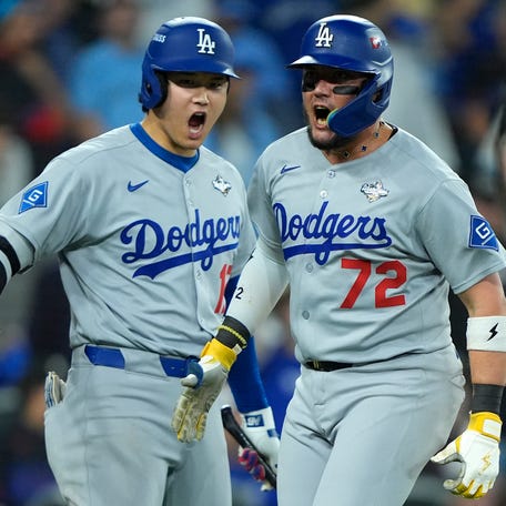 Miguel Rojas celebrates his home run in the ninth inning with Shohei Ohtani.