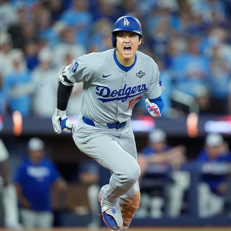 Los Angeles Dodgers two-way player Shohei Ohtani runs after hitting a single against the Toronto Blue Jays in the fifth inning of Game 7 of the 2025 World Series at Rogers Centre.