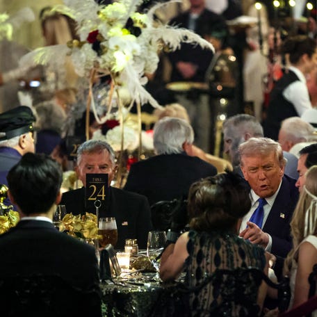 President Donald Trump talks with guests during a Halloween party at his Mar-a-Lago estate on Oct. 31, 2025, in Palm Beach, Florida.
