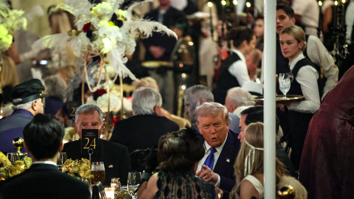 President Donald Trump talks with guests during a Halloween party at his Mar-a-Lago estate on October 31, 2025 in Palm Beach, Florida. Trump is spending the weekend at his Mar-A-Lago estate in Palm Beach, Florida.