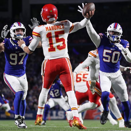 Patrick Mahomes #15 of the Kansas City Chiefs throws as Joey Bosa #97 and Greg Rousseau #50 of the Buffalo Bills defend during the third quarter in the game at Highmark Stadium on November 02, 2025 in Orchard Park, New York.