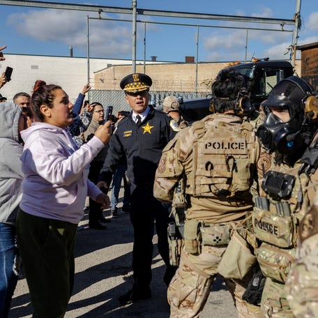 Federal agents confront community members during a standoff, after President Donald Trump ordered increased federal law enforcement presence to assist in crime prevention, in Chicago, Illinois, U.S., October 23, 2025.