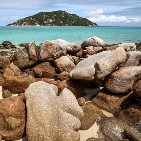 This photo taken on April 4, 2024, shows coral reefs behind rocks on Lizard Island on the Great Barrier Reef, located 270 kilometres (167 miles) north of the city of Cairns.