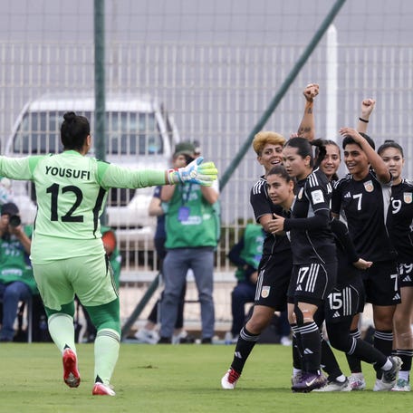 Afghan goalie Fatima Yousufi runs toward her teammates to celebrate after scoring their first goal during the FIFA Unites Women's Series 2025.