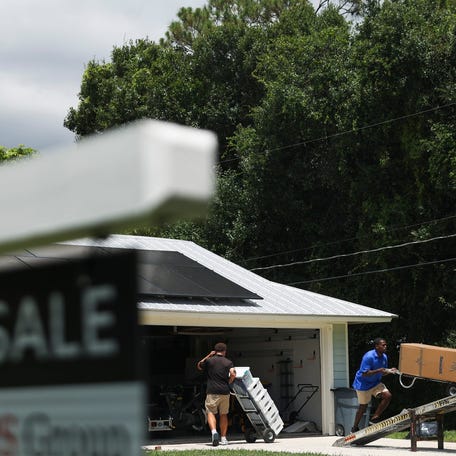 A White Glove Moving, Storage & Delivery crew pack and load personal belongings off Southwest Cinnamon Court in Martin County on Wednesday, June 18, 2025.