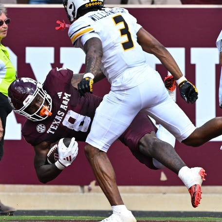 Texas A&M running back Le'Veon Moss (8) scores a touchdown as Missouri safety Sidney Williams (3) defends during their 2024 game at Kyle Field.