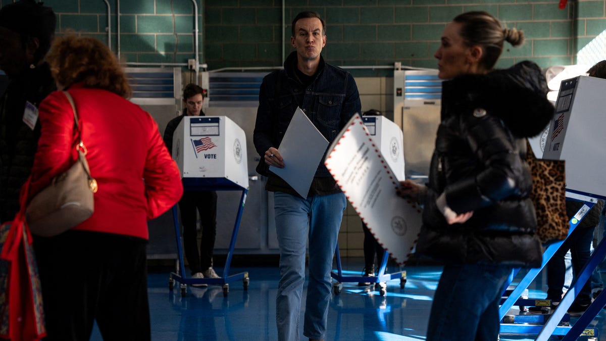 Voters submit their ballots at a polling site on Election Day in the New York City election in Brooklyn on Nov. 4, 2025.