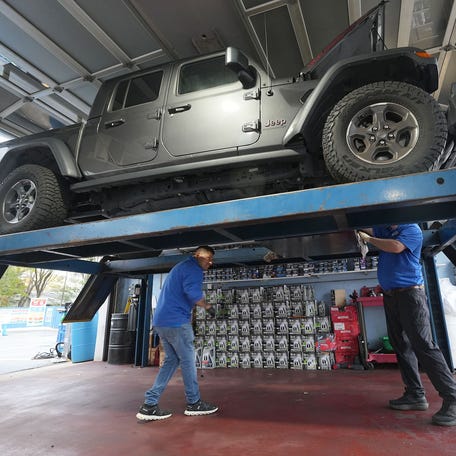 The Prestige Auto Spa NJ crew does an oil change at the Toms River business Monday, November 3, 2025. The full-service car wash is celebrating its fourth anniversary under new ownership.