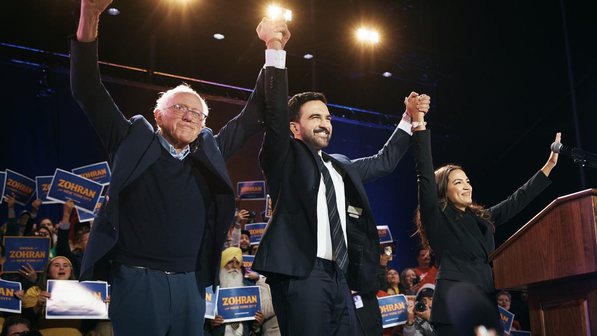 New York Mayoral Candidate Zohran Mamdani, center, celebrates with Sen. Bernie Sanders, I-Vermont, and Rep. Alexandria Ocasio-Cortez, D-New York, at a rally on Oct. 26, 2025 at Forest Hills Stadium in the Queens borough of New York City.