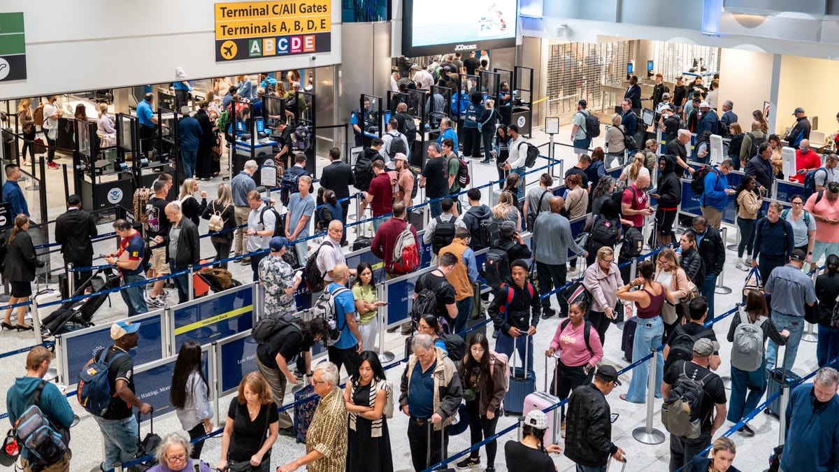 People wait in line at a security checkpoint at the George Bush Intercontinental Airport on Nov. 6, 2025 in Houston, Texas. Federal Aviation Administrator Bryan Bedford has announced that the FAA will be reducing flights by 10% in 40 major airports around the country in an effort to keep airspace safe amid staffing shortages due to the government shutdown.