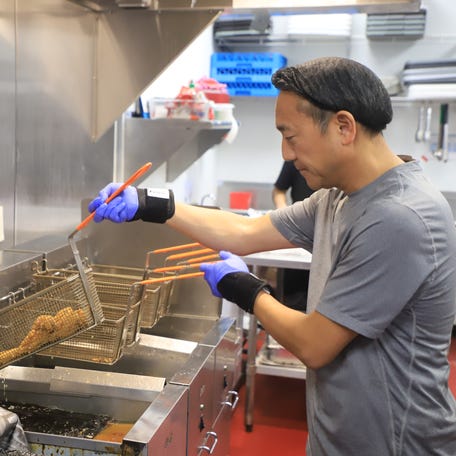 Daniel Lee, the owner of 92 Chicken in Pooler prepares his Korean fried chicken. He's one of the Pooler businesses that has seen a drop in clientele since the Hyundai raid in September.