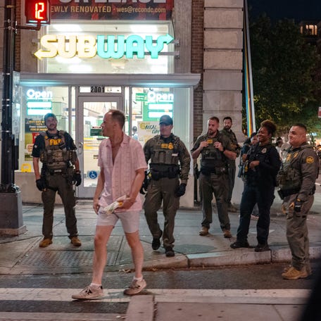 FBI and Border Patrol officers speak with Sean Charles Dunn, 37, before he allegedly assaulted law enforcement by throwing a wrapped sandwich on Aug.10, 2025, in Washington, DC. Three months later, a jury found Dunn not guilty of assault.