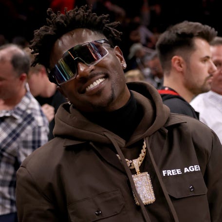 Former Tampa Bay Buccaneers wide receiver Antonio Brown poses for photographers after the game between the Atlanta Hawks and the LA Clippers at State Farm Arena.