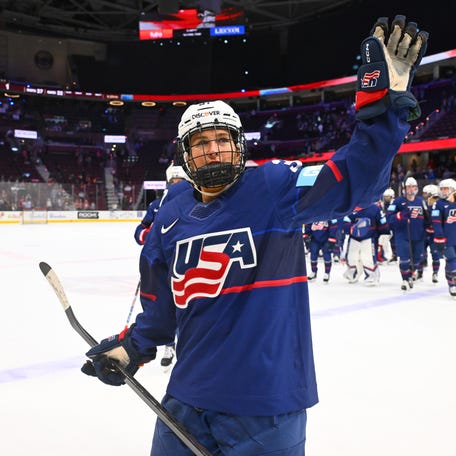 Abbey Murphy of the United States waves to the fans after her hat trick, all on power-play goals, led the U.S. women to a 4-1 win over Canada in the first game of the Rivalry Series.