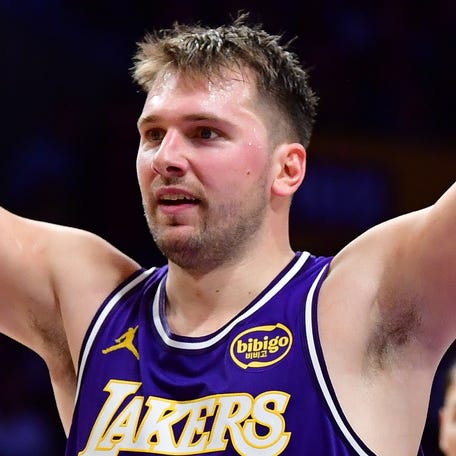 Los Angeles Lakers guard Luka Doncic (77) reacts after scoring a basket against the San Antonio Spurs during the first half at Crypto.com Arena.