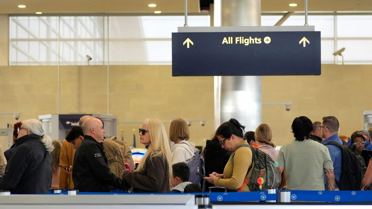 People wait in the TSA security line inside the McNamara Terminal at Detroit Metro Airport in Romulus on Thursday, Nov. 6, 2025. The airport is one of 40 expected to see a gradual reduction in flight operations.