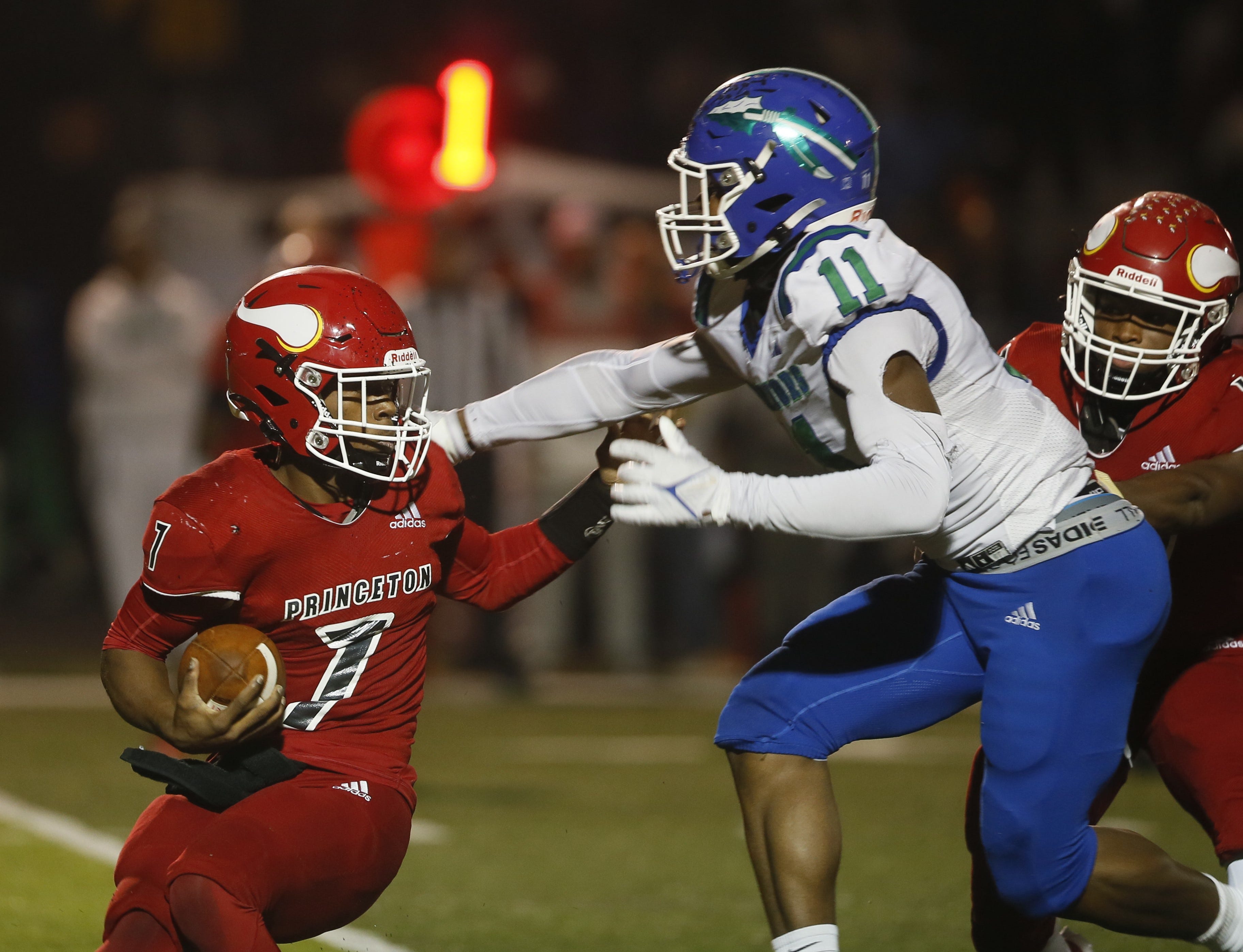 Winton Woods junior Kehyon Roberts (11) tries to bring down Princeton senior David Hambrick as Winton Woods faced Princeton in an OHSAA Division I football playoff game Nov. 7, 2025 at Fairfield High School.