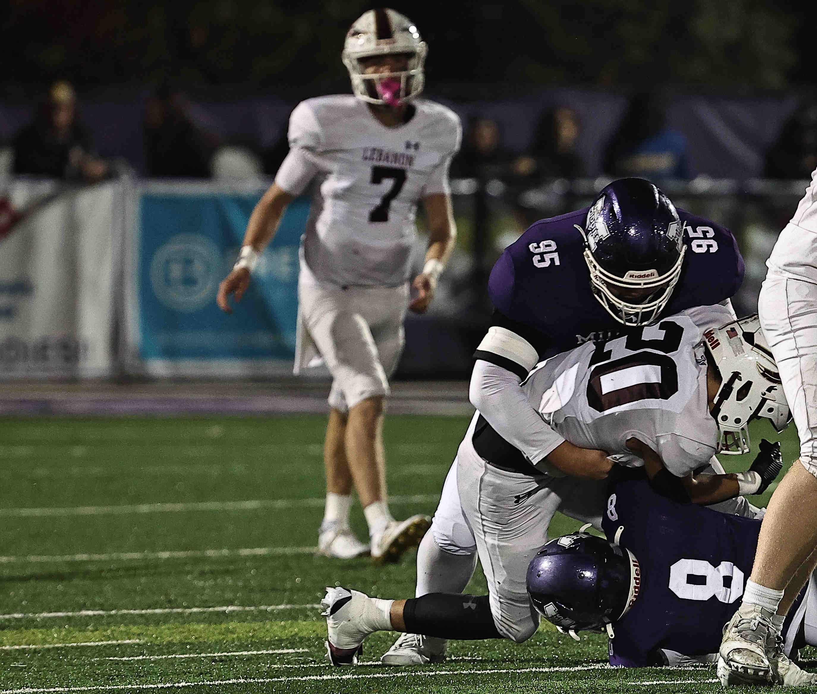 Middletown's Gavin Monk (95) and C.J. Bryant (8) tackle Lebanon's Logan Schmenk during Middletown's 31-0 OHSAA Division I regional quarterfinal playoff win over Lebanon, Friday, Nov. 7, 2025.