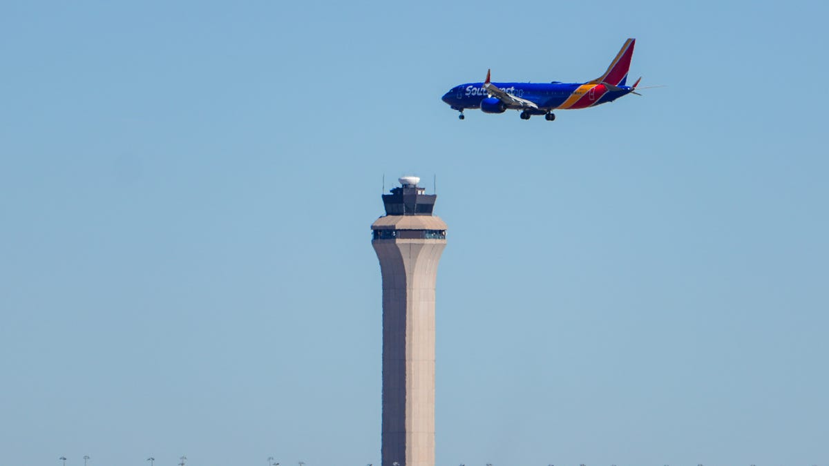 Southwest Airlines Flight 1589, operated by a Boeing 737 MAX 8 aircraft, comes in for a landing in front of the air traffic control tower at Denver International Airport on Nov. 9, 2025.