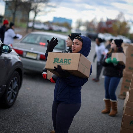 Volunteers load boxes of food into cars during an event held by the Community Food Bank of New Jersey to deliver emergency food relief to federal workers and SNAP recipients amid the U.S. government shutdown in Leonia, New Jersey, U.S., November 6, 2025.