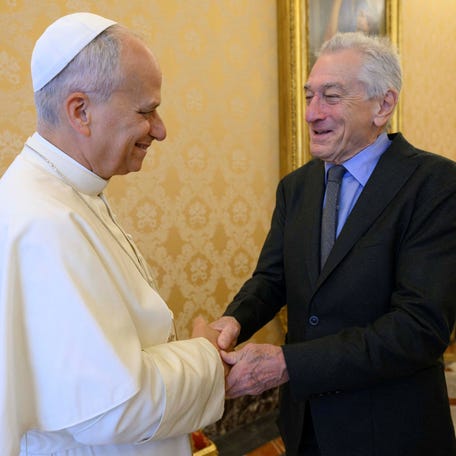 Pope Leo XIV shakes hands with Robert De Niro at the Vatican on Nov. 7, 2025.