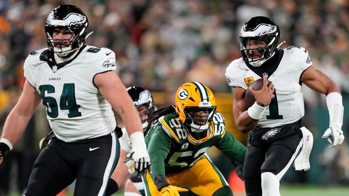 Nov 10, 2025; Green Bay, Wisconsin, USA; Philadelphia Eagles quarterback Jalen Hurts (1) scrambles against the Green Bay Packers in the first half at Lambeau Field. Mandatory Credit: Jeff Hanisch-Imagn Images