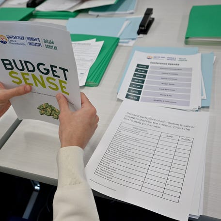 United Way of Central MA staff put together pamphlets for Dollar Scholars financial literacy program.