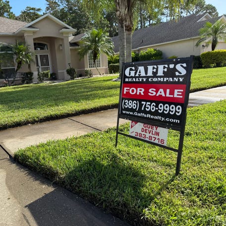 A for-sale sign can be seen in front of this house.