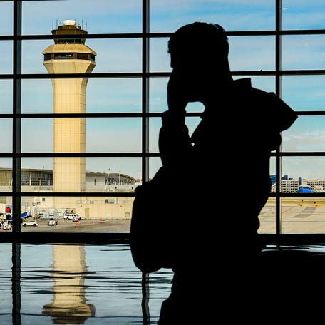 People are pictured walking inside the McNamara Terminal at Detroit Metro Airport on Nov. 6, 2025.