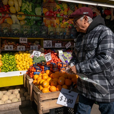 A man walks by a food market on November 6, 2025 in the Brooklyn borough of New York City.