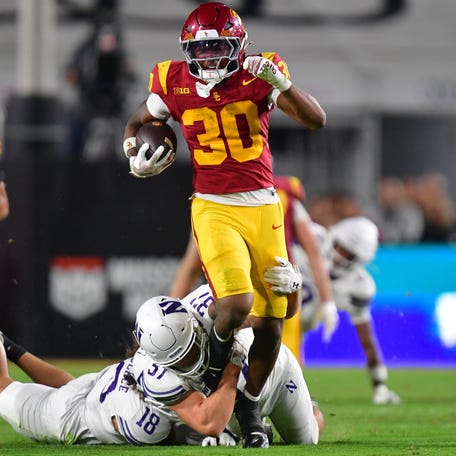Southern California running back King Miller (30) carries the ball against Northwestern during the first half at the Los Angeles Memorial Coliseum.