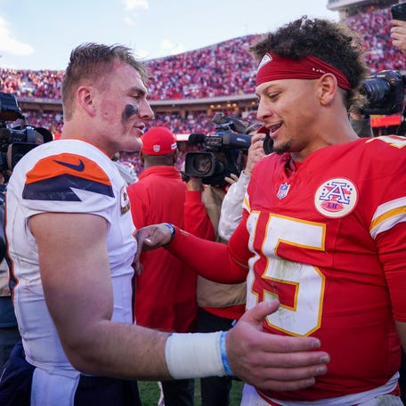 Nov 10, 2024; Kansas City, Missouri, USA; Denver Broncos quarterback Bo Nix (10) talks with Kansas City Chiefs quarterback Patrick Mahomes (15) after the game at GEHA Field at Arrowhead Stadium. Mandatory Credit: Denny Medley-Imagn Images