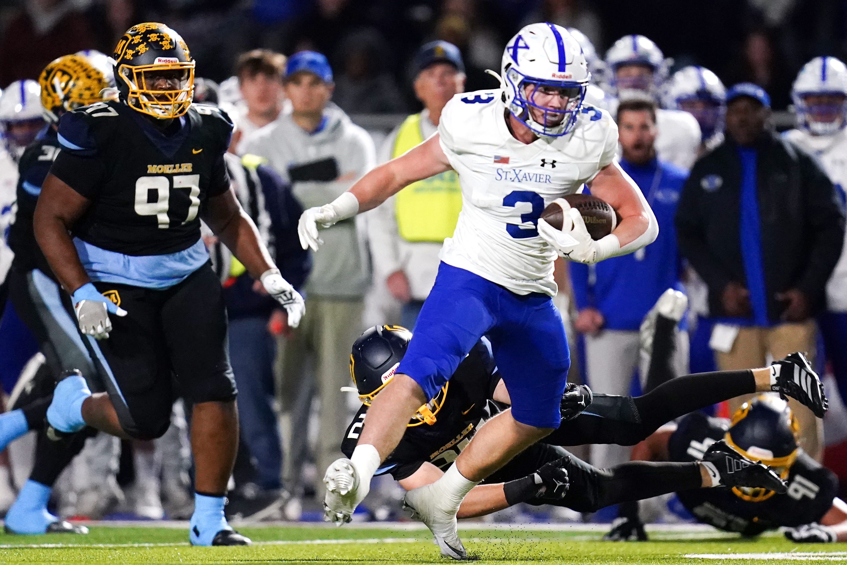 St. Xavier Bombers Daniel Vollmer (3) runs the ball in the first half of a Division I regional semifinal high school football game between the St. Xavier Bombers and Moeller Crusaders, Friday, Nov. 14, 2025, at Welcome Stadium in Dayton, Oh.