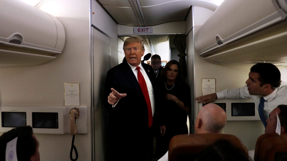 U.S. President Donald Trump talks to the media aboard Air Force One during a flight from Washington to Topeka, Kansas, U.S., October 6, 2018.