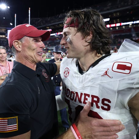 Oklahoma football coach Brent Venables hugs quarterback John Mateer after the Sooners defeated Alabama at Bryant-Denny Stadium on Nov. 15, 2025 in Tuscaloosa, Ala.