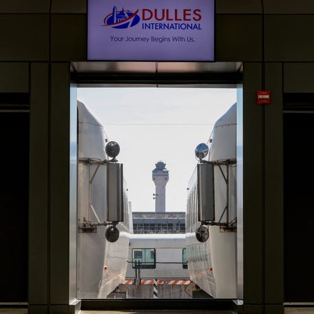 Passenger shuttles transport travelers at Dulles International Airport in Northern Virginia as the U.S. government opened back from the longest shutdown in its history.