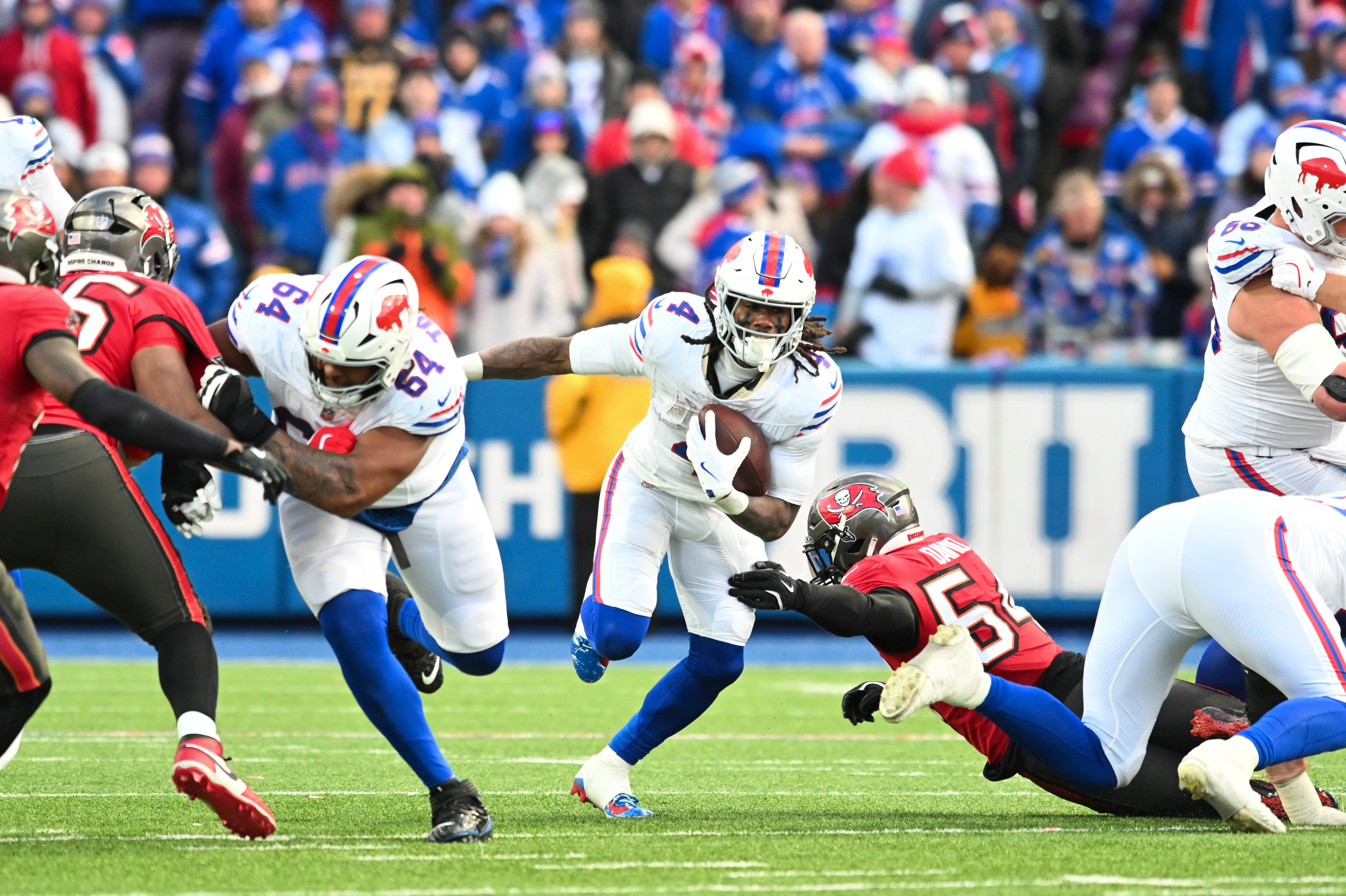 Nov 16, 2025; Orchard Park, New York, USA; Buffalo Bills running back James Cook III (4) runs the ball against the Tampa Bay Buccaneers during the second half of the game at Highmark Stadium. Mandatory Credit: Mark Konezny-Imagn Images