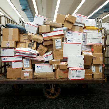 U.S. Postal Service (USPS) packages await delivery at the Lincoln Park Carriers Annex in Chicago on Nov. 29, 2012.