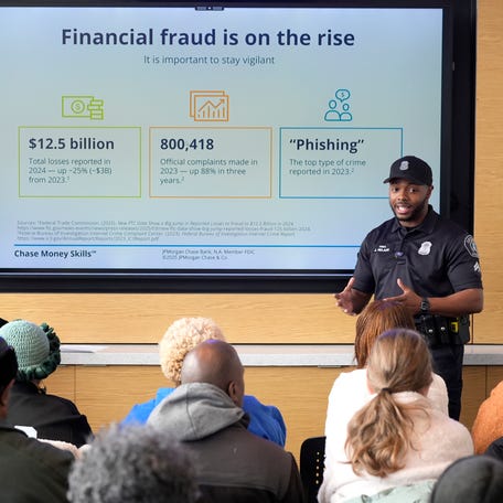 Gail Taylor, the Detroit Community Manager for Chase Bank, left, listens as Jalon Nelson of the Detroit Police Department, speaks to a senior citizen community group about various scams to be aware of during a workshop at the Corktown Community Center on Michigan Avenue in Detroit on Tuesday, Nov. 18, 2025.