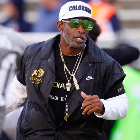 Colorado football coach Deion Sanders takes the field before his team's game against Arizona at Folsom Field.
