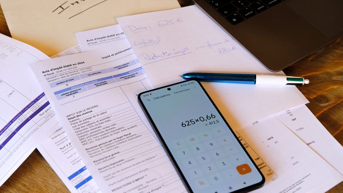 Illustration of a woman preparing her 2024 income tax return for the calculation of 2025 personal income tax on the tax administration website impot.gouv.fr in her living room in Valence, France, on April 9, 2025. (Photo by Nicolas Guyonnet / Hans Lucas / Hans Lucas via AFP) (Photo by NICOLAS GUYONNET/Hans Lucas/AFP via Getty Images)
