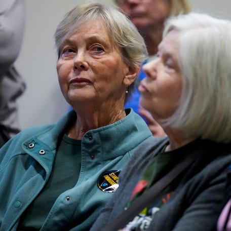 Organizer Anne Janzen listens to speakers during a meeting of the Butler County Commissioners at the Butler County Government Services Building in Hamilton, Ohio, on Tuesday, Nov. 18, 2025.