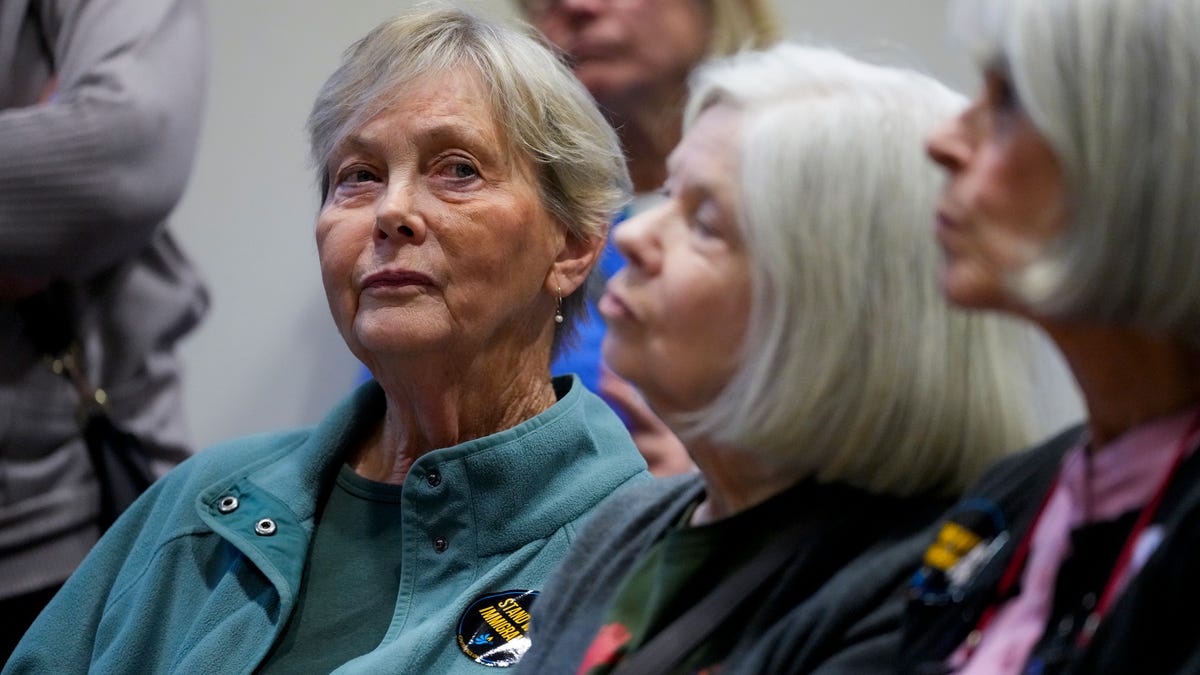 Organizer Anne Janzen listens to speakers during a meeting of the Butler County Commissioners at the Butler County Government Services Building in Hamilton, Ohio, on Tuesday, Nov. 18, 2025.