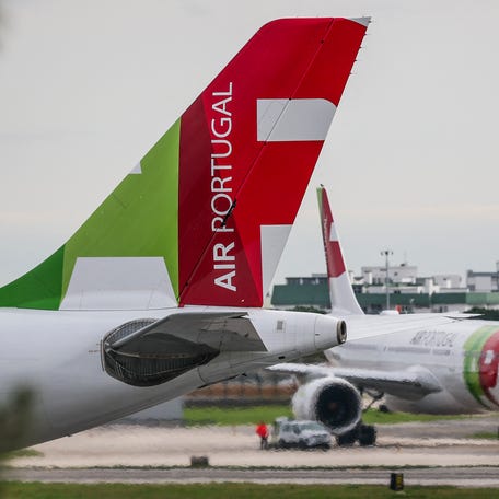 TAP Portuguese airline aircraft are pictured at Humberto Delgado airport in Lisbon on November 19, 2025.
