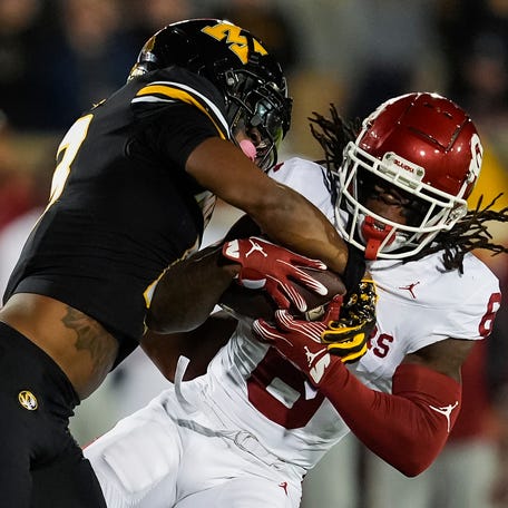 Oklahoma wide receiver Deion Burks (6) is tackled by Missouri safety Daylan Carnell (13) during their 2024 game at Faurot Field at Memorial Stadium.