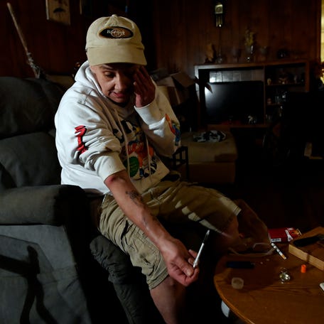 Sheila Dummett, 58, prepares to inject heroine at her home after attending Bethany Church's weekly clean needle exchange program earlier in the afternoon on Tuesday, Nov. 4, 2025, in Tazewell, Tenn.