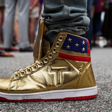 Dom Lucre wears "The Never Surrender High-Tops" sneakers as supporters of Republican presidential candidate and former U.S. President Donald Trump await his arrival for the first 2024 presidential debate with U.S. President Joe Biden, hosted by CNN in Atlanta, at Hartsfield-Jackson Atlanta International Airport, Georgia, U.S., June 27, 2024.