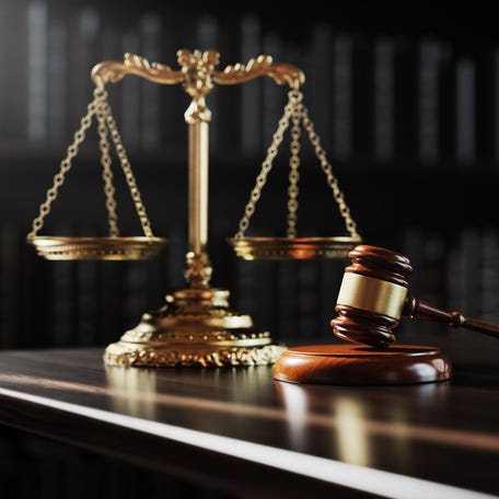 Legal concept: Scales of justice and and the judge's gavel hammer as a symbol of law and order on the background of books.