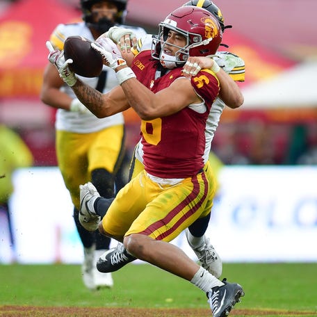 Southern California wide receiver Makai Lemon (6) catches a pass against the coverage of Iowa defensive back Zach Lutmer (6) during their game at Los Angeles Memorial Coliseum.